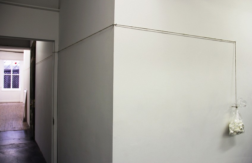 Jiri Kovanda, Untitled (equilibrium)
2007, One hammer, some marshmallows in a plastic transparent bag, natural rope from one room to another, held with some metal hooks